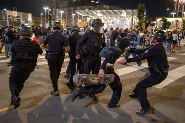 Police detain a person during a protest in downtown Los Angeles